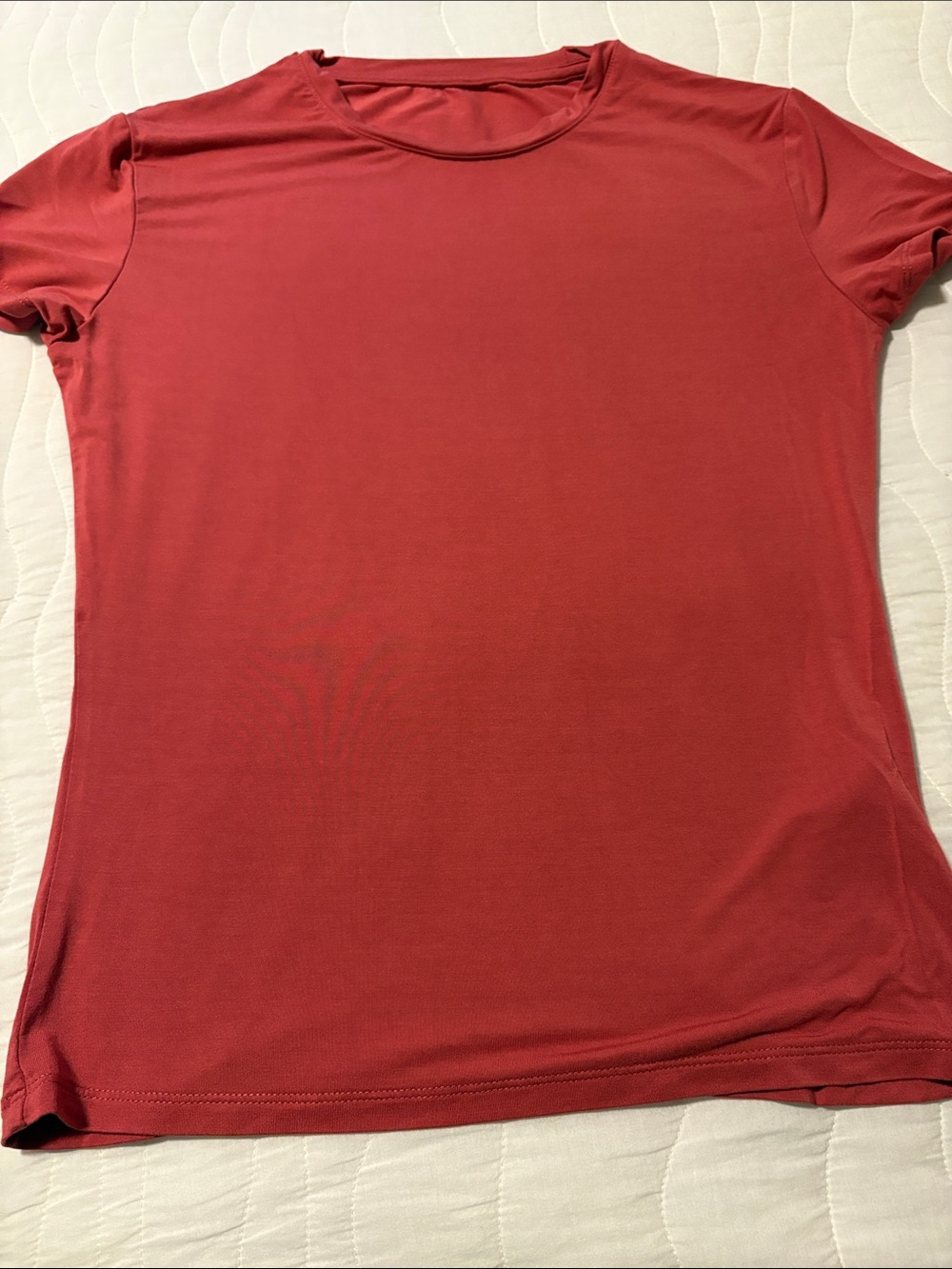 Super stretchy T-shirt. The color is a reddish pink.